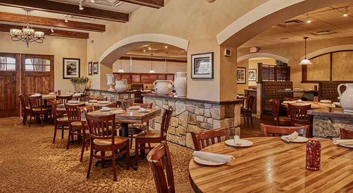 The inside of Stancato's restaurant. The well lit dining room is filled with wooden table tops an wooden chairs, creating a classy dining experience.