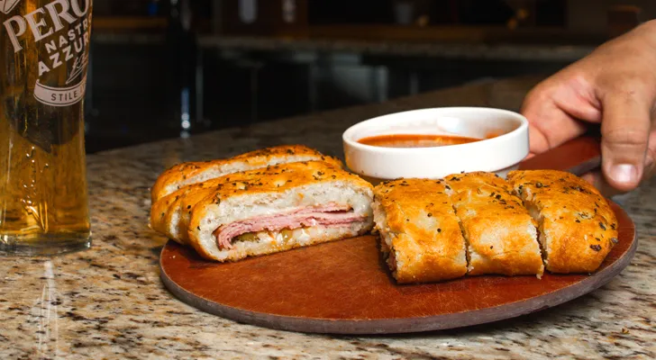 Stromboli with marinara dipping sauce and a Peroni draft beer
